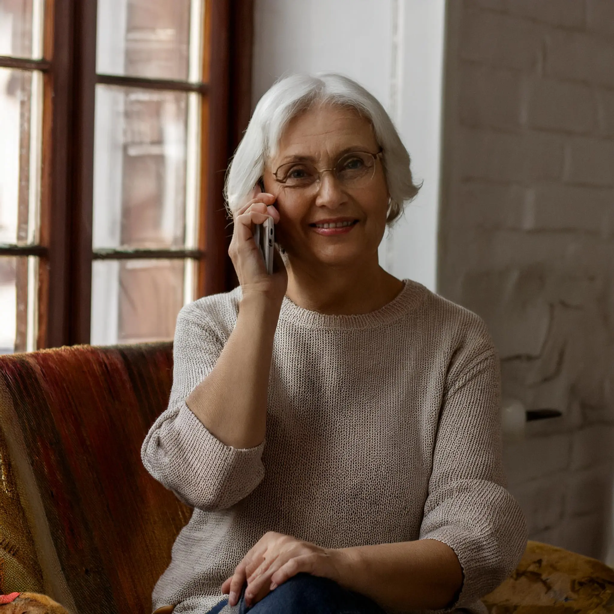 Senior woman smiling while talking on a mobile phone